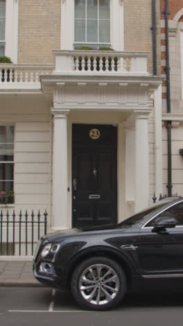 Vertical-Video-Of-Luxury-Cars-Outside-Office-Buildings-In-Grosvenor-Street-Mayfair-London-UK-1